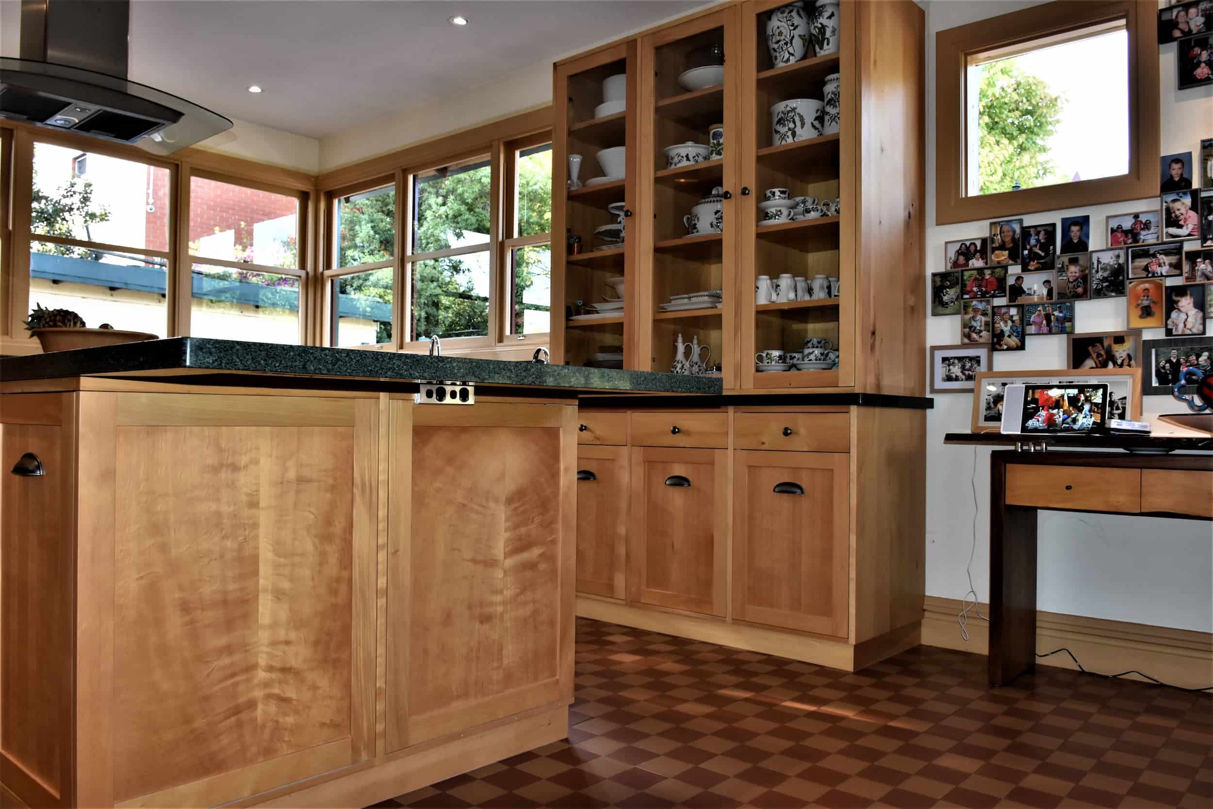 Huon pine kitchen with glass display cabinets and timber island