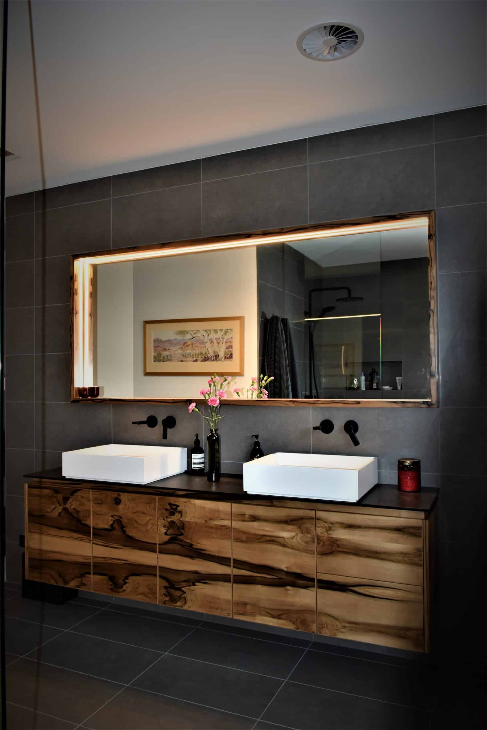 Custom timber bathroom vanity with live edge mirror and double basin sinks