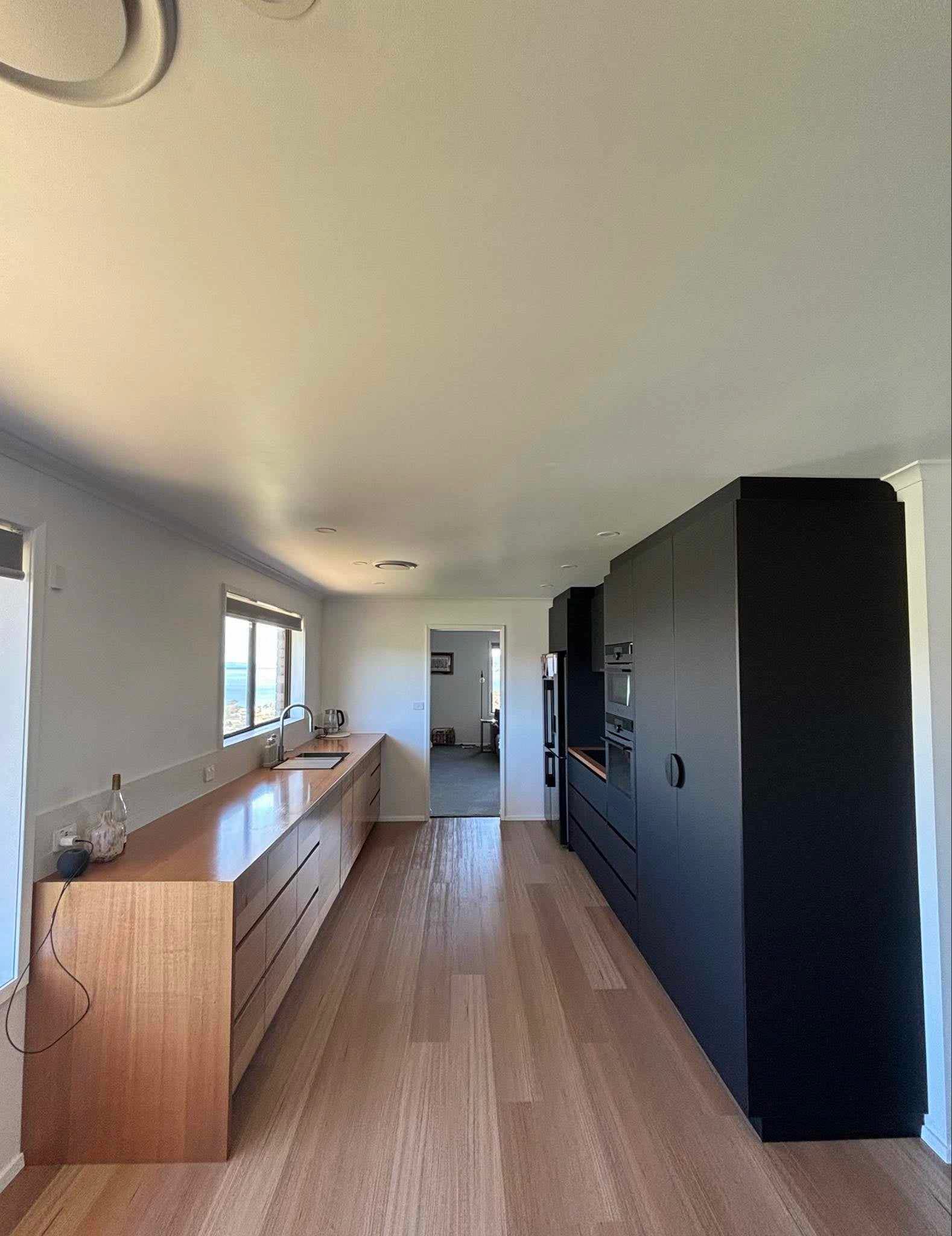 Tasmanian Oak kitchen with black panel cabinetry